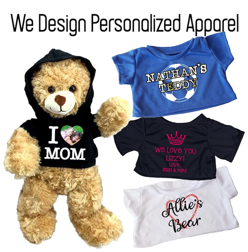 May include: A plush teddy bear wearing a black hoodie with "I MOM" printed on it, and three personalized t-shirts. One blue shirt says "NATHAN'S TEDDY", a black shirt says "We love you Lizzy!", and a white shirt says "Allie's Bear". The text "We Design Personalized Apparel" is at the top.