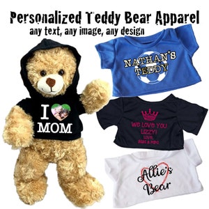 May include: Four personalized teddy bear shirts. The first shirt is black with a white heart and the text "I MOM". The second shirt is blue with the text "NATHAN'S TEDDY" and a soccer ball. The third shirt is black with a crown and the text "We love you Lizzy! Love, Gaga & Papa". The fourth shirt is white with a red heart and the text "Allie's Bear".