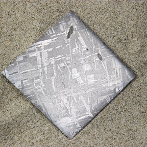 Gibeon Meteorite slice Fine Cut and Polish.  from Africa.  41 Grams. 5.4 x 5.2 x .3 cm.