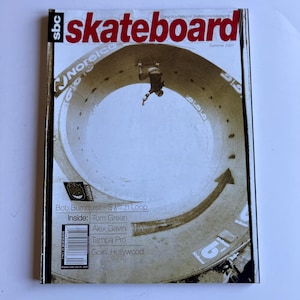 May include: A vintage skateboard magazine cover with the word "skateboard" in large, bold, red letters. The cover features a skater in a skate bowl. Text includes "Summer 2001" and names like Bob Burnquist and Tom Green.