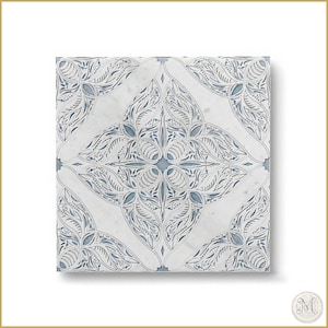 May include: Square white tile with a detailed, symmetrical floral design. The pattern features intricate cut-out details with a light blue background. The tile has a marble-like texture and is suitable for home decor.