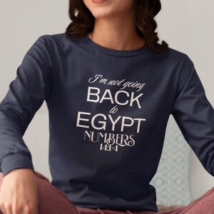 May include: Navy blue long-sleeve shirt with the text "I'm not going BACK to EGYPT NUMBERS 14:1-4" in white script. The shirt is made of a soft material.