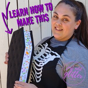 May include: A black coffin-shaped object with a white center panel decorated with colorful sprinkles and small candy-like shapes. The text "LEARN HOW TO MAKE THIS" is written in purple, and a purple circular logo reads "just add glitter SATX".