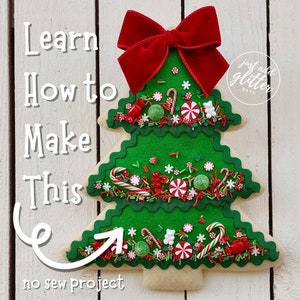 May include: Learn how to make this no sew Christmas tree cookie. The cookie is decorated with green icing, red and white candy canes, red and white sprinkles, and a red velvet bow.