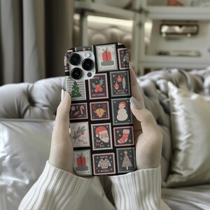 May include: A phone case featuring a festive Christmas stamp design. The case is black with a grid of colorful stamps, including images of a Christmas tree, Santa Claus, gifts, and ornaments. The stamps have a vintage aesthetic with the words "Merry Christmas" and "Warm Wishes".