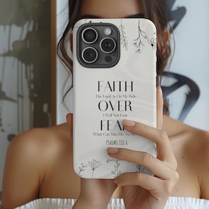 May include: White phone case with a black floral design and the text "FAITH The Lord Is On My Side OVER I Will Not Fear FEA What Can Man Do To Me PSALMS 118:6"