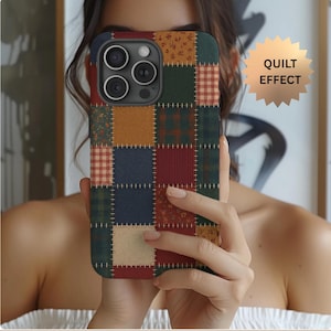 May include: A patchwork-style phone case featuring a quilt effect design. The case showcases a variety of fabric patterns in shades of red, green, blue, and tan, stitched together. The case has a black camera module.