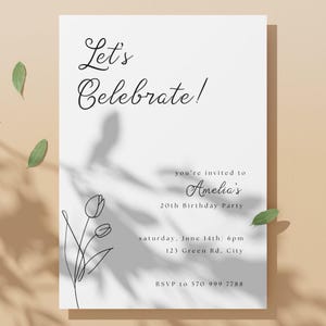 May include: A white invitation card with the text "Let's Celebrate!" in elegant script. The card includes details for Amelia's 20th birthday party, with a floral line art design and RSVP information. Green leaves and shadows add a natural touch.