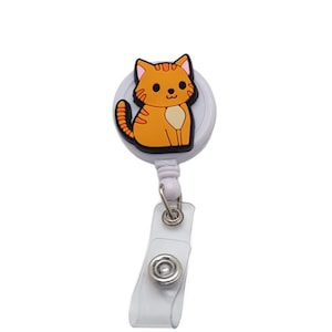 May include: White retractable badge holder with a cartoon orange cat design.