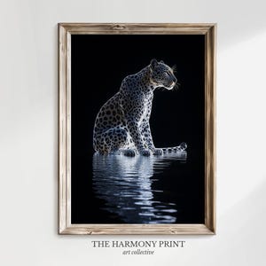 Könnte beinhalten: Ein Schwarzweißfoto eines Leoparden, der in einem Gewässer sitzt. Der Leopard blickt nach rechts aus dem Bild. Das Wasser reflektiert das Licht des Leoparden.
