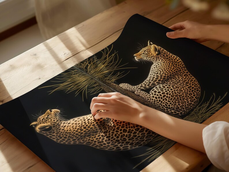 May include: A black background with two leopards printed on it. The leopards are in a golden color and are facing different directions. The leopards are surrounded by a golden colored plant.