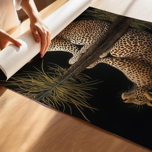May include: A black and gold leopard print design on a black background. The leopard is curled up with its head resting on its paws. The design is surrounded by a border of gold and black.