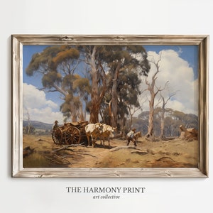 May include: A framed landscape painting depicts a rural scene with a horse-drawn cart and figures. The artwork features a muted color palette of browns, greens, and blues, with tall trees and a cloudy sky. The text "THE HARMONY PRINT art collective" is at the bottom.
