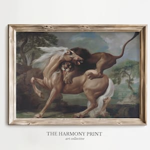 May include: A framed vintage print depicts a dramatic scene of a lion attacking a horse. The artwork features a brown lion on the back of a tan horse with a white mane and tail. The print is set against a landscape background with trees and a cloudy sky.