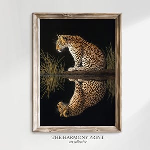 May include: A framed print of a leopard sitting by a body of water, looking at its reflection. The leopard is brown and black with spots. The background is black with green grass.