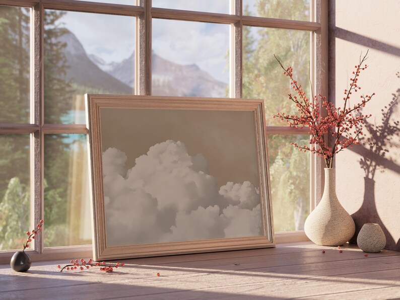 May include: A framed picture of a cloudy sky with a mountain range in the background, seen through a window. The picture is on a wooden surface with a vase of red berries and a small vase.