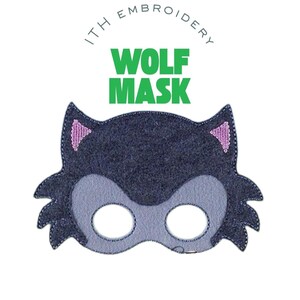 May include: A dark grey felt wolf mask with a light grey muzzle and eye openings. The ears have pink embroidered accents. The words "WOLF MASK" are in green block letters above the mask. The text "ITH EMBROIDERY" is above the words "WOLF MASK".