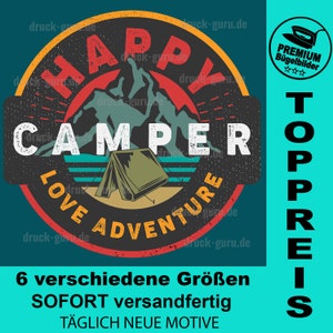 May include: A red, white, and blue circular design with the text "HAPPY CAMPER LOVE ADVENTURE" in a vintage style. The design features a mountain range and a tent. The text "TOPPREIS" is in a vertical column to the right of the circle. The text "6 verschiedene Größen SOFORT versandfertig TÄGLICH NEUE MOTIVE" is below the circle.