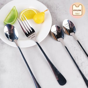 May include: Four silver utensils with engraved messages. The fork says "I forking love you, mum". The spoons say "Spooning since", "Dad, I love you", and "Spooning since".