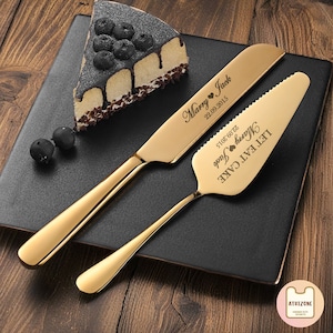 May include: Gold cake knife and server set with the text "Let's Eat Cake" and "Marry Jack 22.09.2015" engraved on the handles.