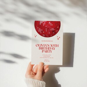 May include: Red and white birthday party invitation with a disco ball graphic. The invitation says "You're invited to Olivia's 30th Birthday Party" and includes the date, time, location, and RSVP information.