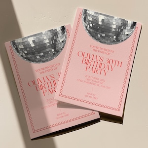 May include: Pink invitation with a disco ball graphic. The text reads "You're invited to the party of Olivia's 30th Birthday Party" with the date and location below. RSVP information is at the bottom.