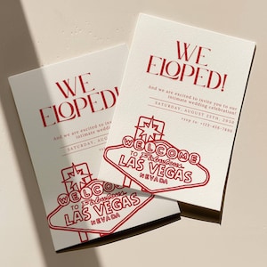 May include: Two ivory wedding announcement cards with red text. The cards read "WE ELOPED!" and include details for an intimate wedding celebration in Las Vegas. A red neon sign graphic says "WELCOME TO FABULOUS LAS VEGAS NEVADA".