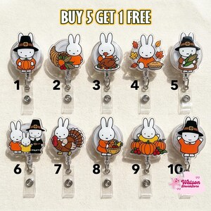 May include: Ten retractable badge reels featuring Miffy in various autumn and Thanksgiving themes, numbered one through ten. Each acrylic topper displays a different seasonal illustration, including pumpkins, turkeys, and harvest motifs. Text reads BUY 5 GET 1 FREE.