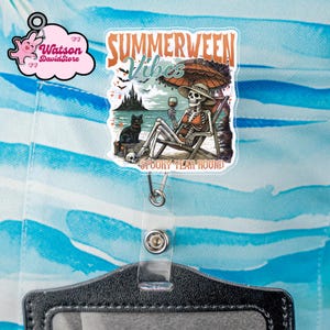 May include: A clear acrylic badge reel featuring a graphic of a skeleton wearing a sun hat and bikini, sitting in a beach chair with a glass of wine and a black cat. The text reads "SUMMERWEEN Vibes" and "SPOOKY YEAR ROUND" with a beach scene.