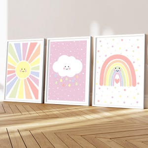 May include: Three framed art prints with weather-themed illustrations. The first shows a smiling sun with colourful rays. The second depicts a cloud with raindrops on a pink background. The third print displays a rainbow with a heart.