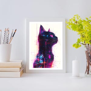 May include: A framed art print featuring a stylized black cat with a cosmic design. The cat's silhouette is filled with vibrant pink, purple, and blue hues, set against a white background. The artwork is displayed on a white surface, with pencils, books, a candle, and flowers nearby.