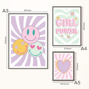 May include: Three framed art prints with a retro theme. One print features three smiley faces, another says "GIRL POWER", and the third has a heart. The prints measure 420mm x 297mm, 297mm x 210mm, and 210mm x 148.5mm.