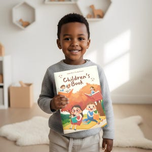 May include: A young child holding a children's book with a colorful illustration. The book cover features the title "Children's Book" and images of children reading. The child is wearing a gray sweater.