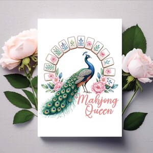 May include: A white card featuring a peacock illustration with a blue and green body and a long, ornate tail. The text "Mahjong Queen" is written in pink script. The design includes a semi-circle of mahjong tiles and pink flowers.