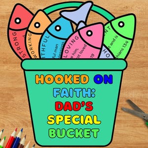 May include: A teal bucket with the words "HOOKED ON FAITH: DAD'S SPECIAL BUCKET" in colorful letters. The bucket holds five colorful fish with words like "STRONG" and "LOVING". A pair of scissors and colored pencils are in the background.