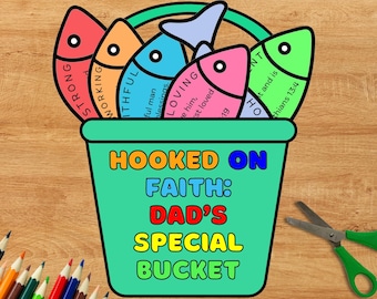 May include: A teal bucket with the words "HOOKED ON FAITH: DAD'S SPECIAL BUCKET" in colorful letters. The bucket holds five colorful fish with words like "STRONG" and "LOVING". A pair of scissors and colored pencils are in the background.