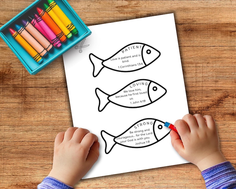 May include: A white paper with three fish-shaped illustrations, each containing a word: "PATIENT", "LOVING", and "STRONG", along with related Bible verses. A child is coloring the bottom fish with a red crayon. A teal crayon box is in the upper left.
