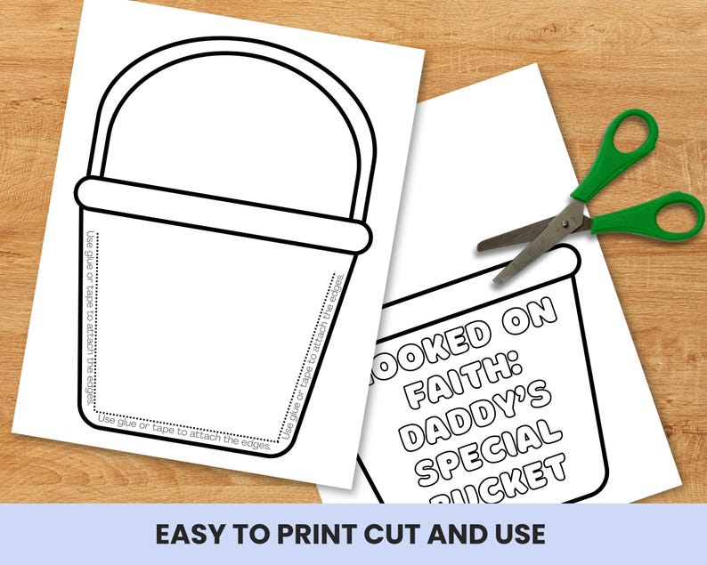 May include: Two white sheets of paper with black outlines of a bucket and text. One sheet has a bucket outline with instructions to glue or tape the edges. The other sheet has the text "HOOKED ON FAITH: DADDY'S SPECIAL BUCKET". A pair of green scissors is also present.