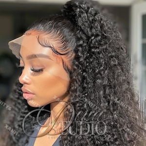 May include: A black curly human hair wig with a lace front. The wig is styled in a high ponytail. The lace front is visible and the wig is laid flat.