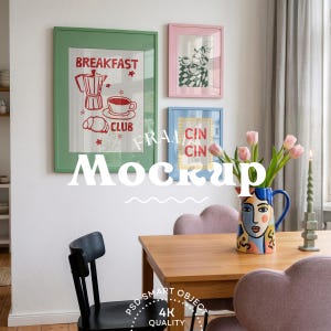 May include: Three framed wall art prints in green, pink, and blue frames. The green frame features a red illustration of a coffee pot, cup, and croissant with the text BREAKFAST CLUB. The blue frame displays the text CIN CIN in red letters.