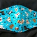 DOGS on Blue. Face Mask .Fits most adults.cotton. poli fabric soft ear holder. Made in Oregon, washable. reusable