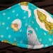 Dr. Seuss Blue . Face Mask .Fits most adults.cotton. poli fabric soft ear holder. Made in Oregon, washable. reusable