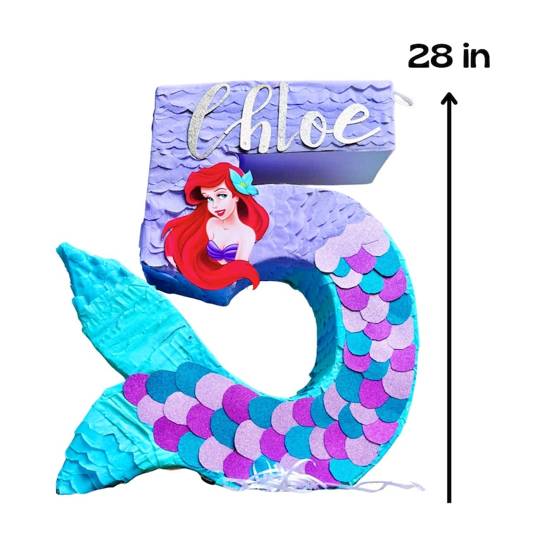 May include: A number 5 pi&ntilde;ata in the shape of a mermaid, 28 inches tall. The pi&ntilde;ata is decorated with blue, purple, and pink scales. It features a mermaid illustration and the name "Chloe" in cursive.