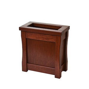 May include: A dark brown wooden storage box with a rectangular opening on the top. The box has a simple design with a smooth finish.