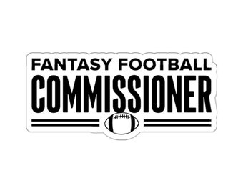 May include: A white sticker with the words "FANTASY FOOTBALL COMMISSIONER" in bold black letters. Below the text is a graphic of a football. The sticker is rectangular with rounded corners.