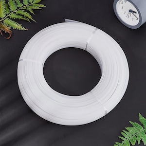 May include: A white coil of plastic tubing, likely for use in crafting or DIY projects.