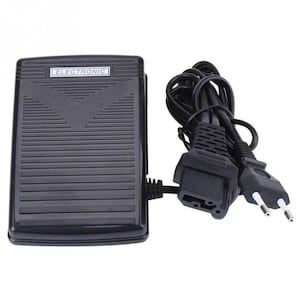 May include: Black foot pedal with a cord and plug. The foot pedal has the word "ELECTRONIC" printed on it.