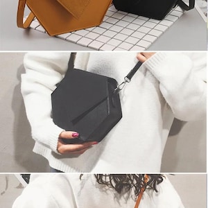 May include: Two geometric shaped handbags, one black and one brown, with a shoulder strap. The bags are made of a soft, textured material.