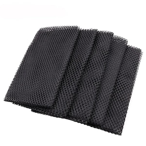 May include: A set of four rectangular black mesh fabric sheets with a consistent open-weave grid pattern. Each sheet is layered slightly offset from the others, displaying a uniform, textured, and semi-transparent material structure throughout.