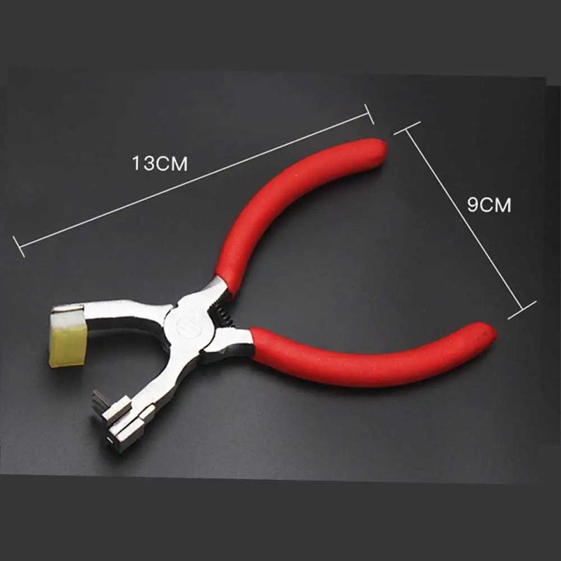May include: Red handled metal punch tool with a yellow plastic piece on the end. The tool is 13 inches long and 9 inches wide.